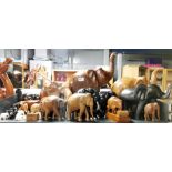 A large group of carved wooden elephants, tallest 44cm.
