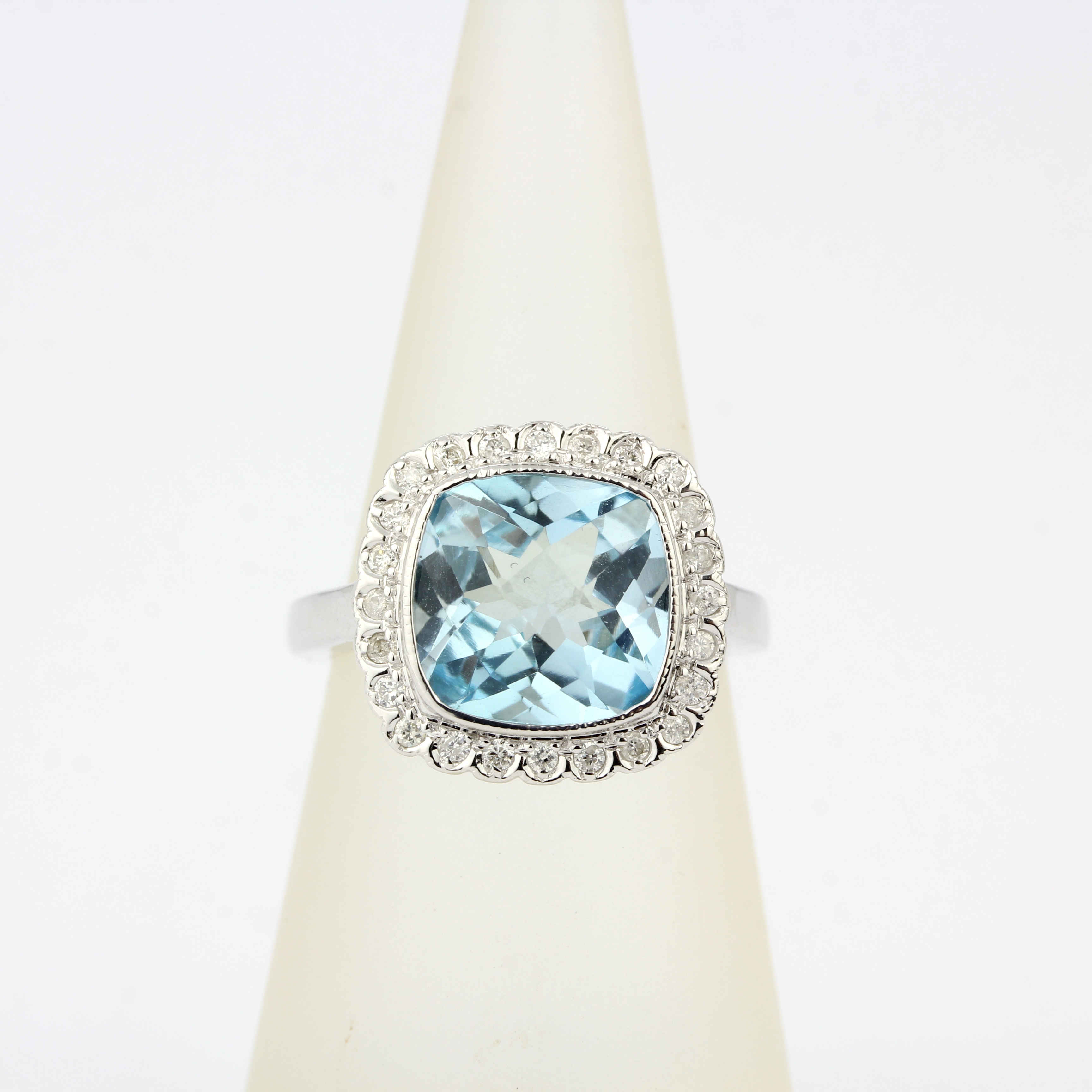 A 9ct white gold ring set with a checker board aquamarine and diamonds, ring size L.