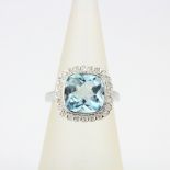 A 9ct white gold ring set with a checker board aquamarine and diamonds, ring size L.