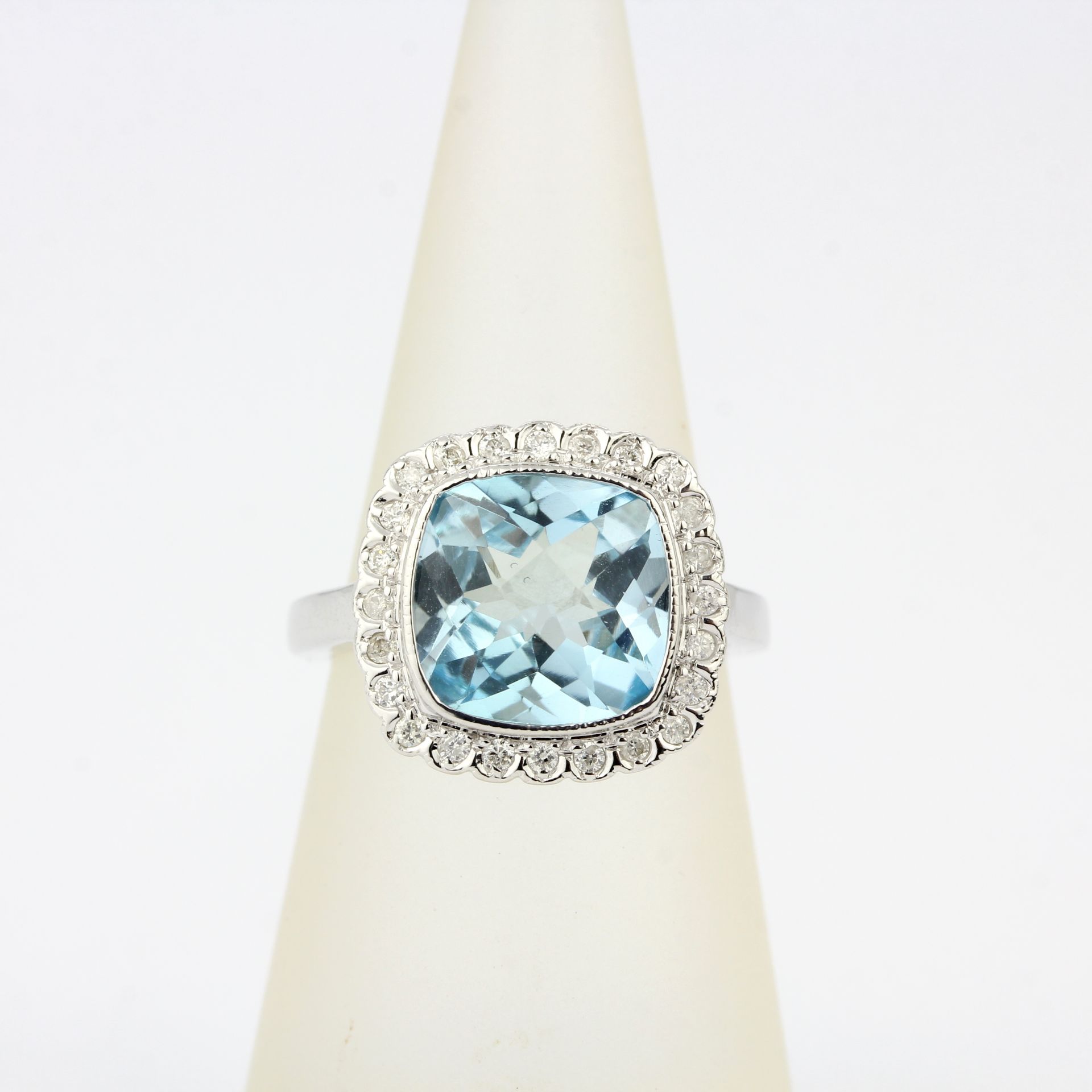 A 9ct white gold ring set with a checker board aquamarine and diamonds, ring size L.