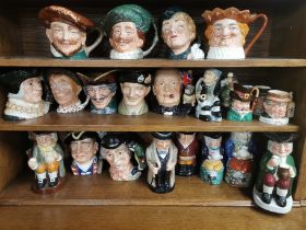 A large group of mixed Royal Doulton and other character jugs.