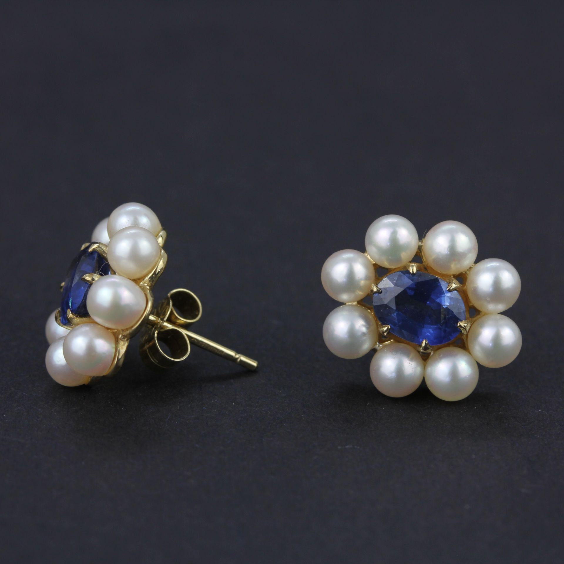 A pair of 9ct yellow gold earrings set with oval cut sapphires surrounded by pearls, L. 1.3cm. - Image 4 of 4