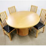 A light beech circular revolving dining table and four chairs, dia 118cm.