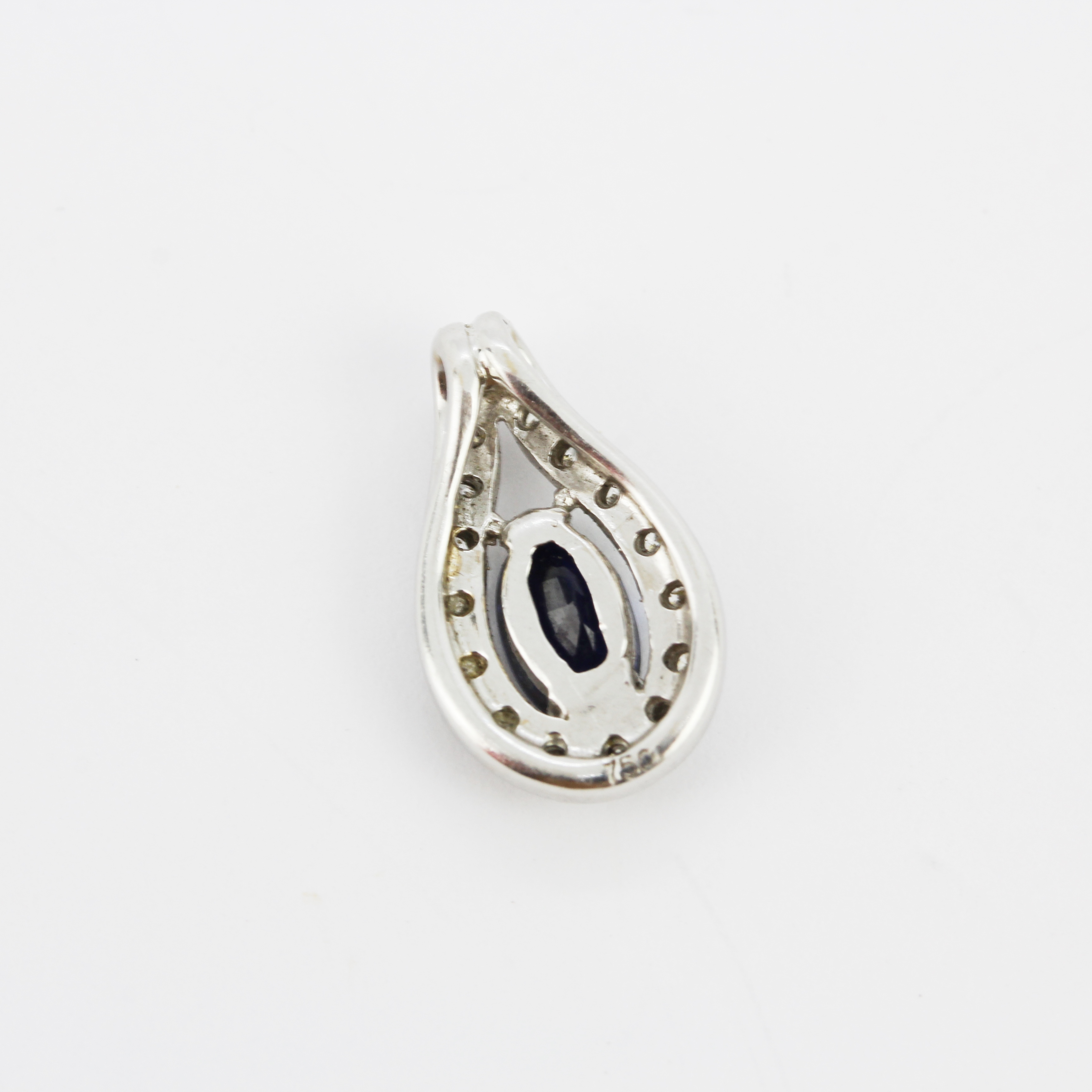 An 18ct white gold pendant set with an oval cut sapphire surrounded by diamonds, L. 1.5cm. - Image 2 of 3