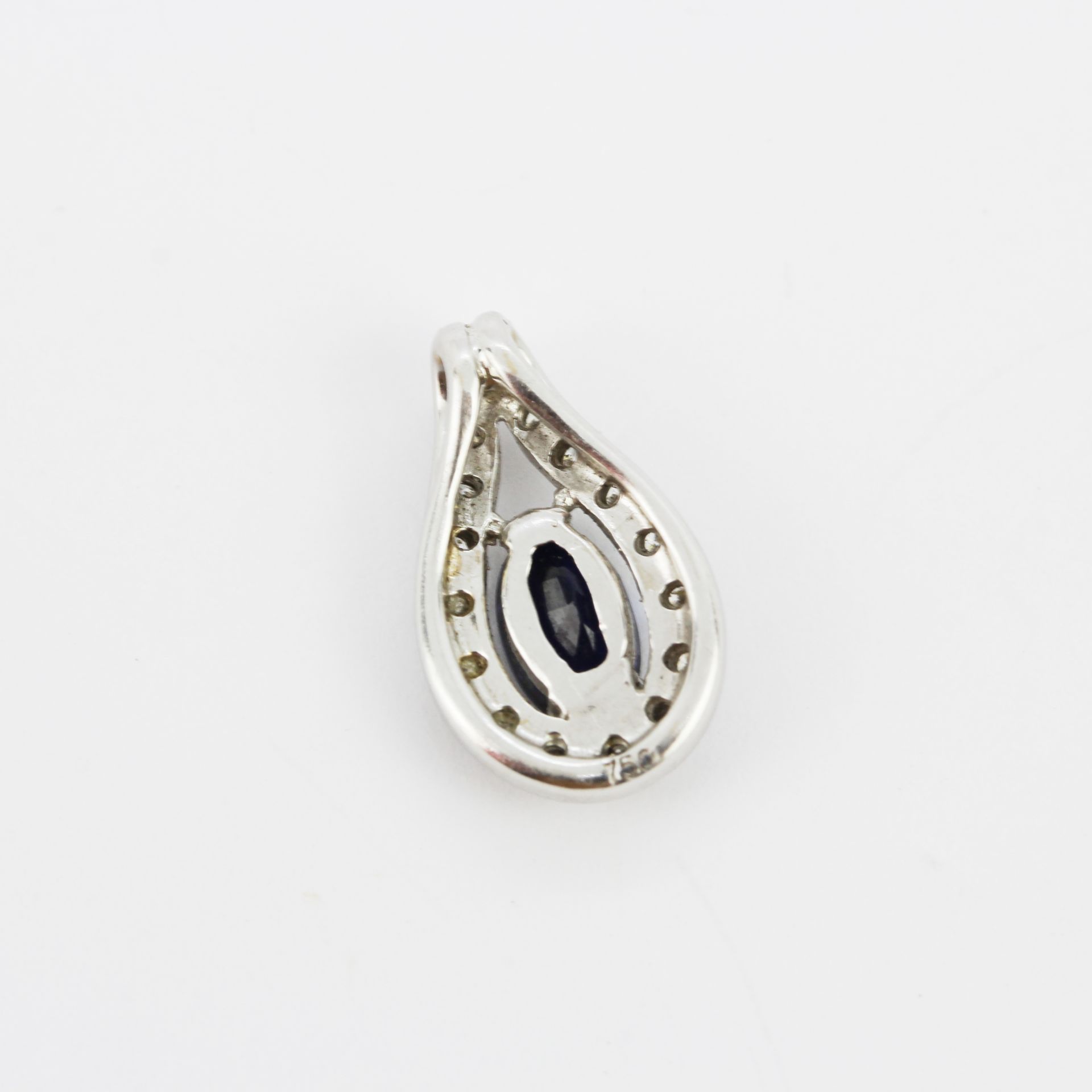 An 18ct white gold pendant set with an oval cut sapphire surrounded by diamonds, L. 1.5cm. - Image 2 of 3