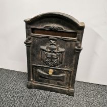 A heavy cast iron letter box, H. 39cm.