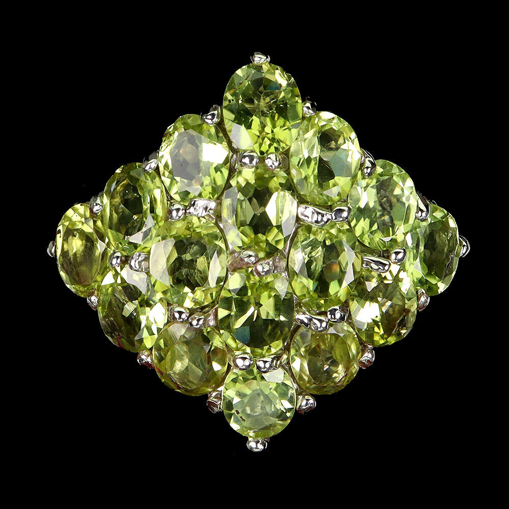 A 925 silver ring set with oval cut peridots, ring size P.