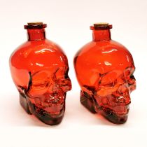 Two glass skull bottles, H. 16cm.