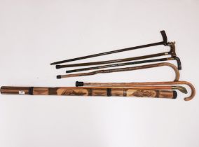 A group of walking sticks and a didgeridoo.