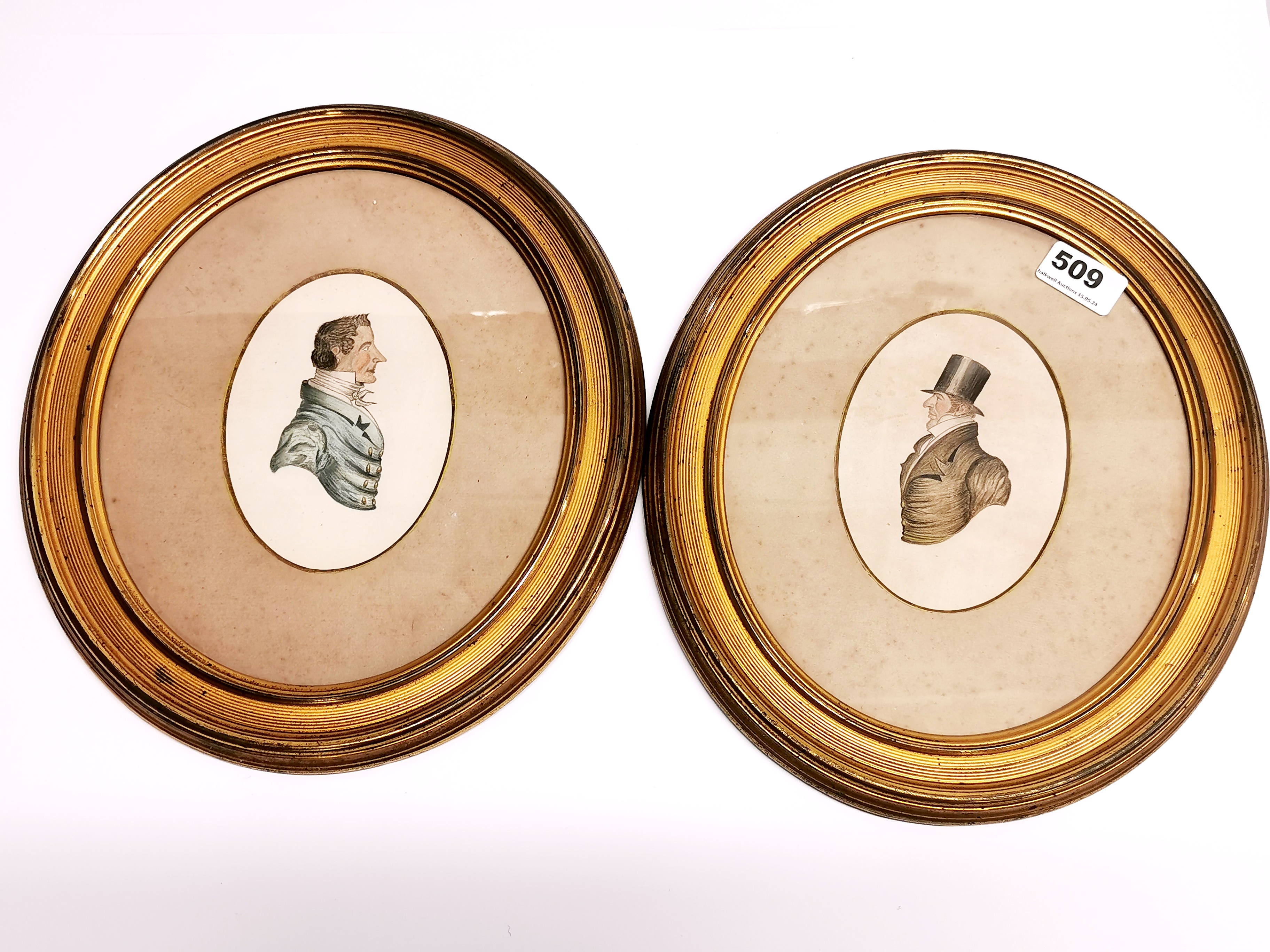 A pair of 19thC gilt framed hand painted miniatures of gentlemen, H. 32cm.