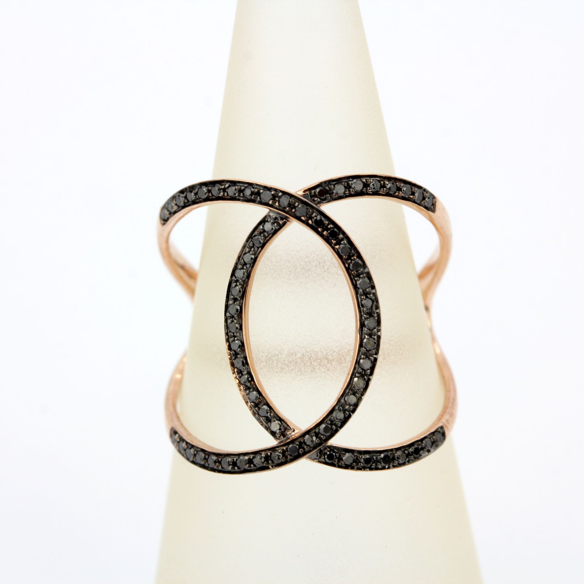 A 9ct rose gold ring set with brilliant cut fancy black diamonds, ring size N.5.