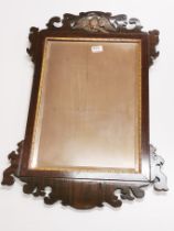 A Regency carved wooden wall mirror, H. 84cm.