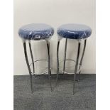 A pair of chromium plated bar stools with blue faux suede seats labelled Primo furniture, London.