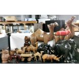 A collection of carved wooden animals etc, largest 54cm.