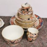 A 19thC Derby style part tea set with an Imari plate.