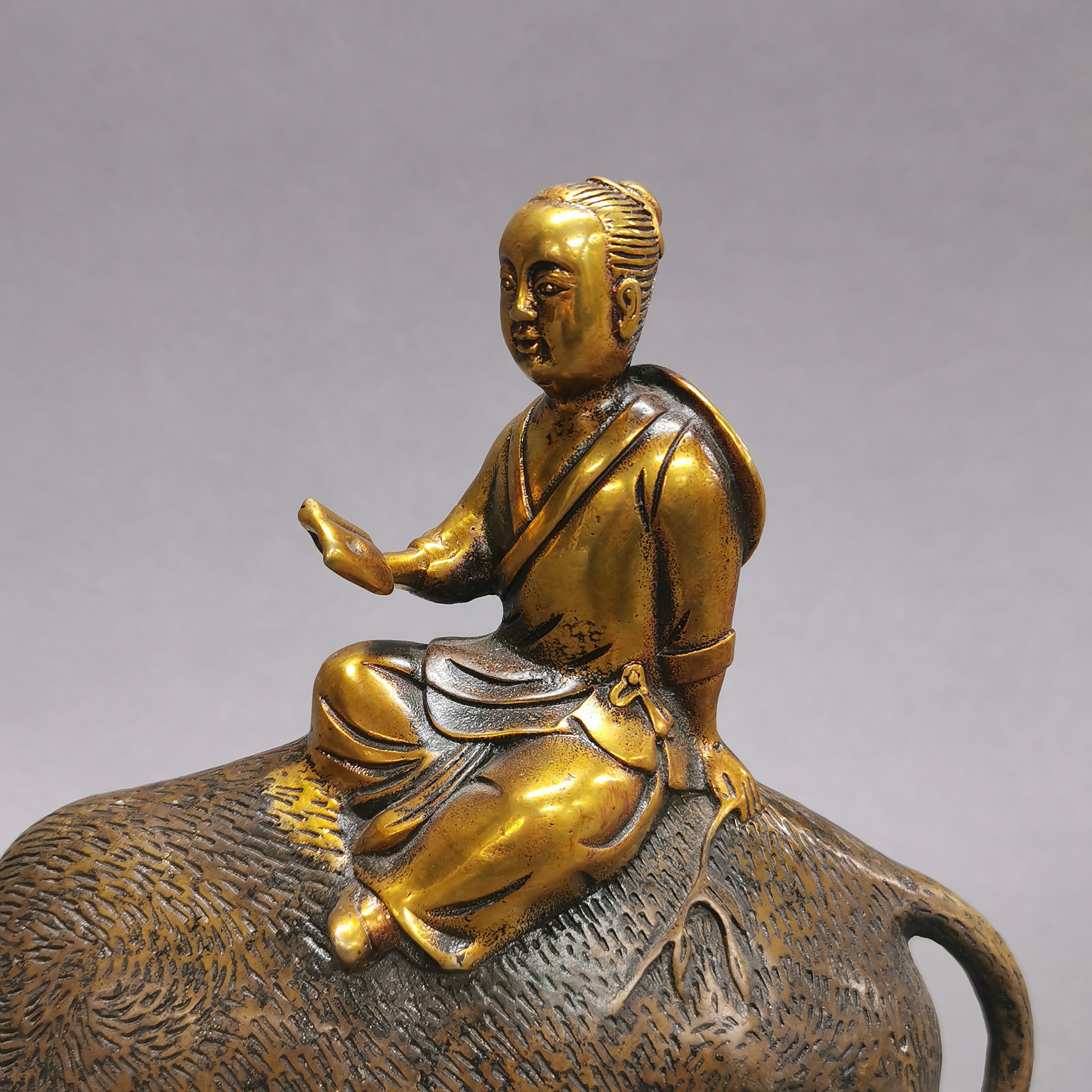 A Chinese gilt bronze figure of a scholar riding a water buffalo, H. 23cm. - Image 2 of 3