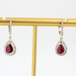 A pair of 18ct white gold drop earrings set with pear cut rubies and diamonds, L. 1.8cm.