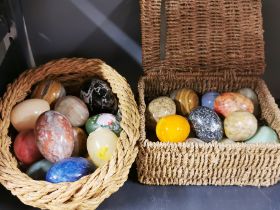 A collection of mixed polished stone eggs, largest 7.5cm.