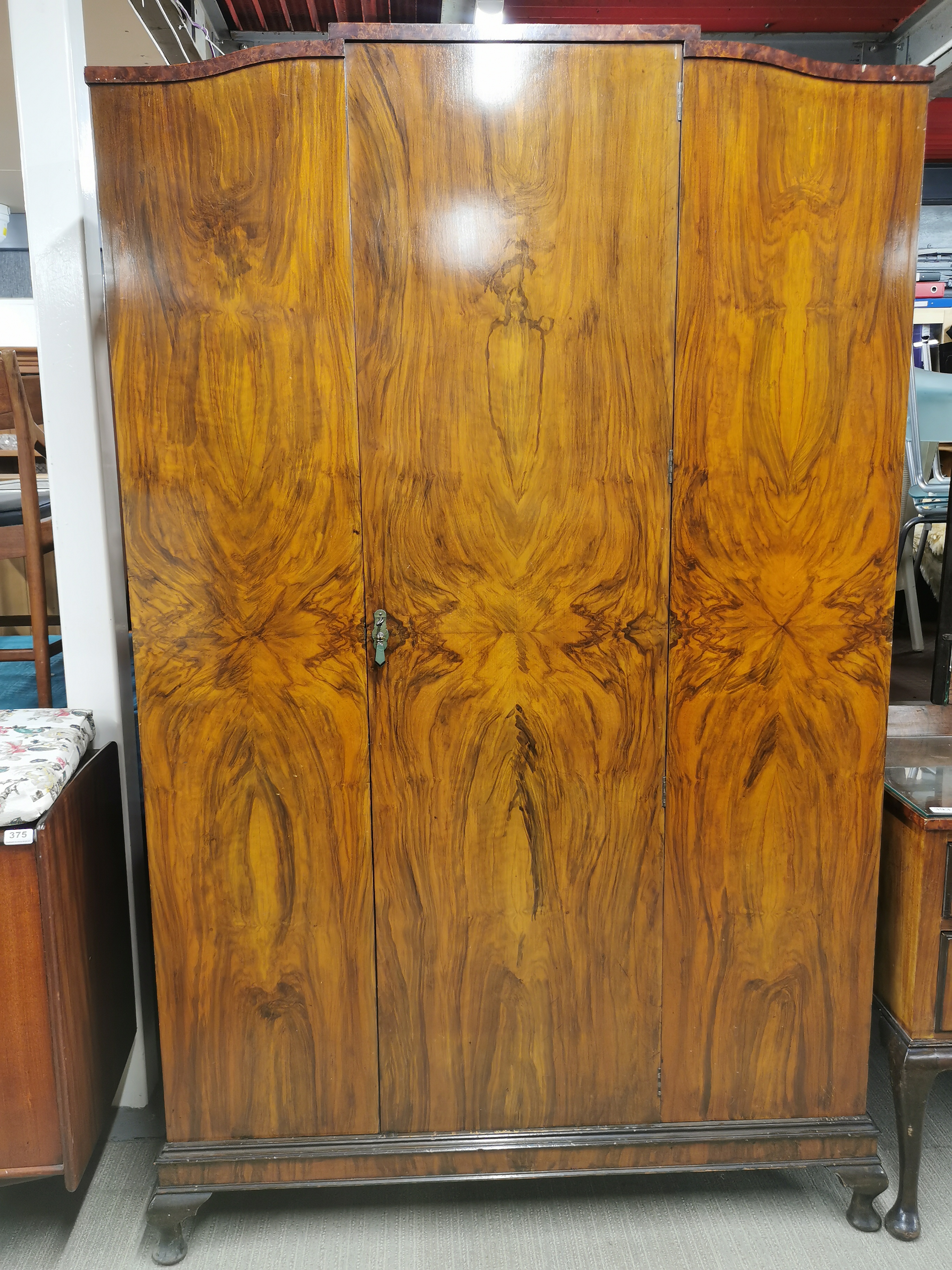 An early 20thC flame mahogany veneered wardrobe, 195 x 120 x 50cm.