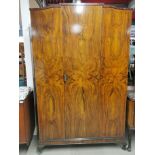 An early 20thC flame mahogany veneered wardrobe, 195 x 120 x 50cm.