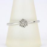 A 9ct white gold diamond set cluster ring, ring size V.5.