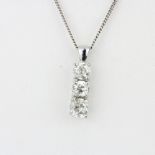 An 18ct white gold (tested) pendant set with three old cut diamonds, approx. 2ct overall, clarity P,