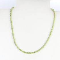 A peridot bead necklace, L. 44cm.
