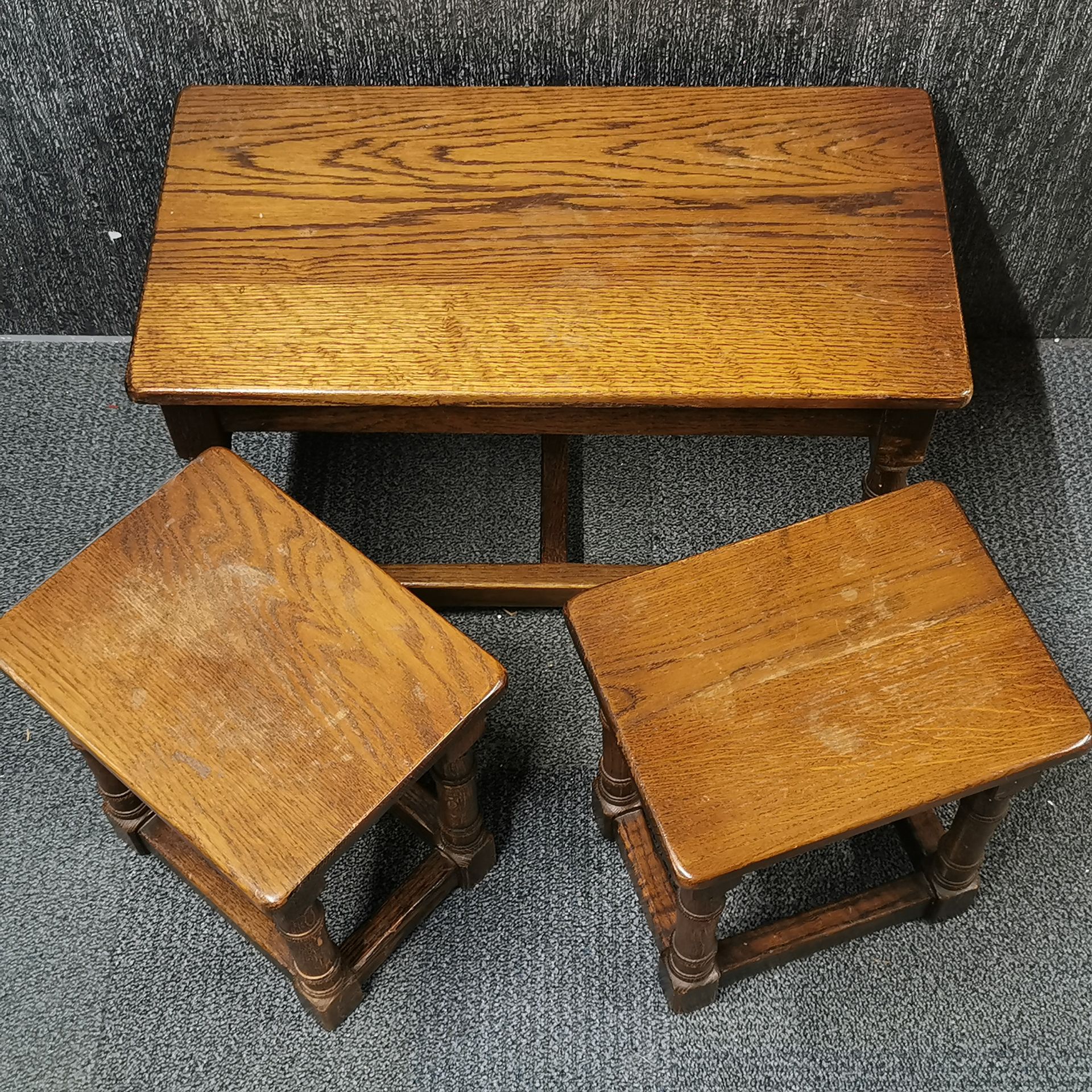 A nest of three heavy oak coffee tables, 68 x 35 x 41cm.