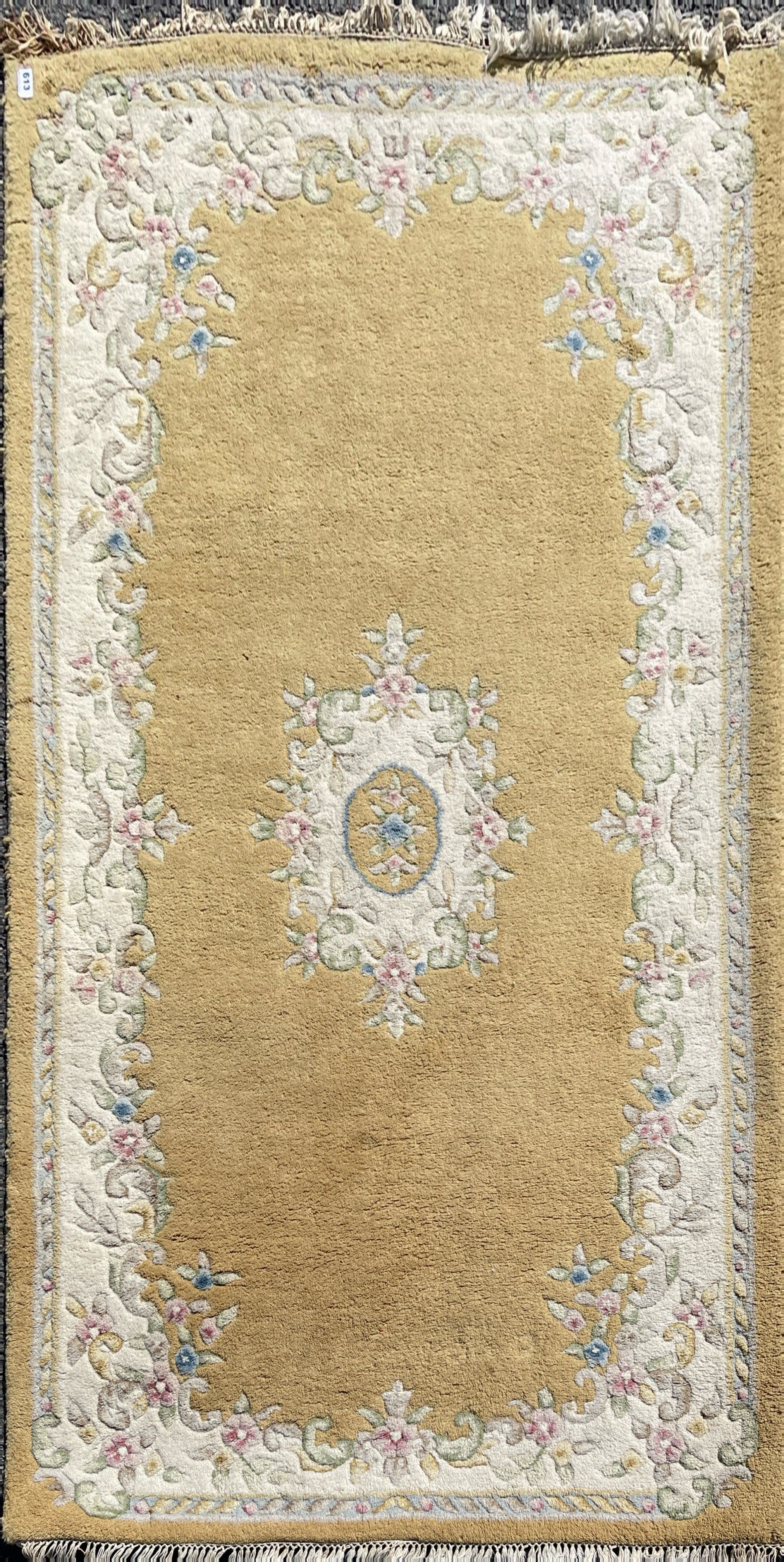 A Chinese design woolen rug, 215 x 125cm.