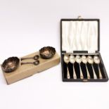A set of hallmarked silver teaspoons with a pair of silver plated salts and spoons.