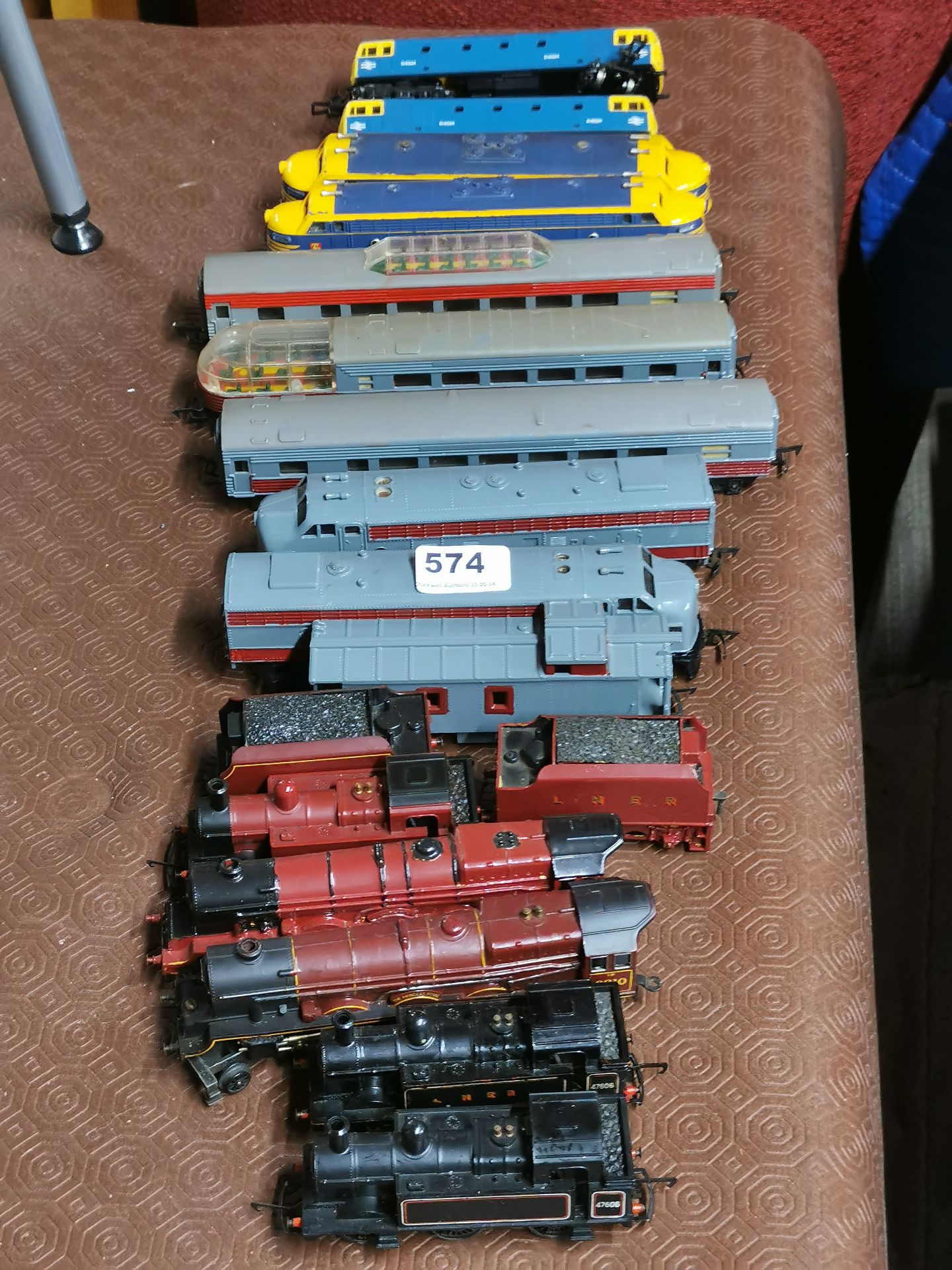 A group of mixed 00 gauge locomotives and rolling stock.