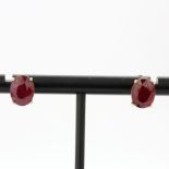 A pair of 9ct yellow gold ruby set stud earrings, L. 0.9cm, one butterfly replaced.