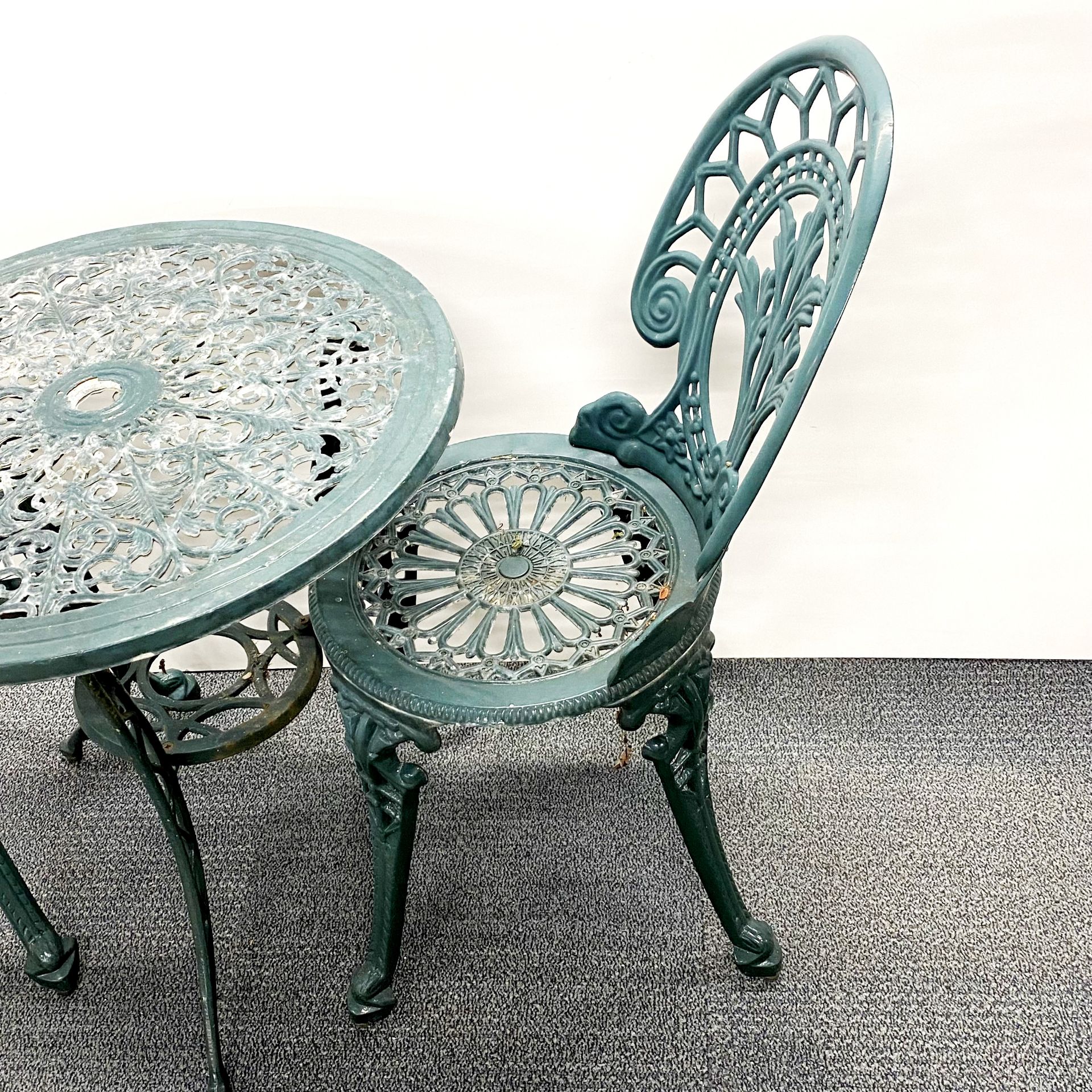 A cast iron garden table and two chairs, table 60 x 63cm. - Image 3 of 3