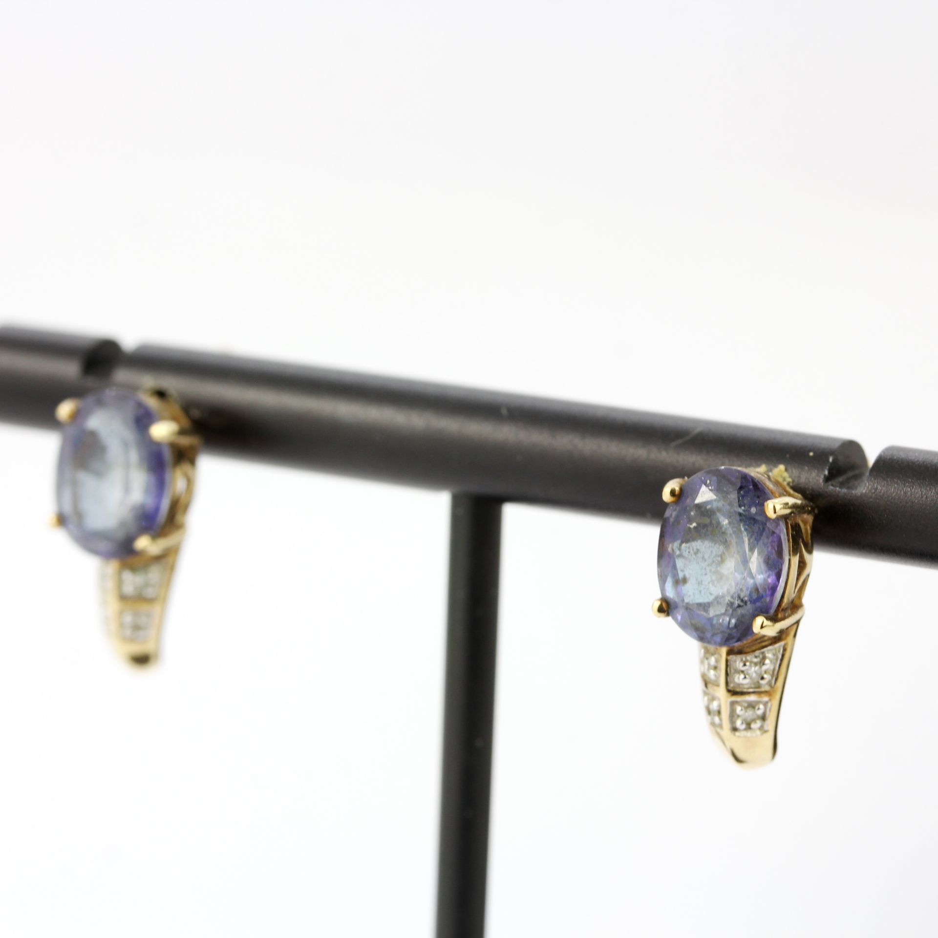 A pair of 9ct yellow gold earrings set with blue topaz and diamonds, L. 1.4cm. - Image 2 of 3