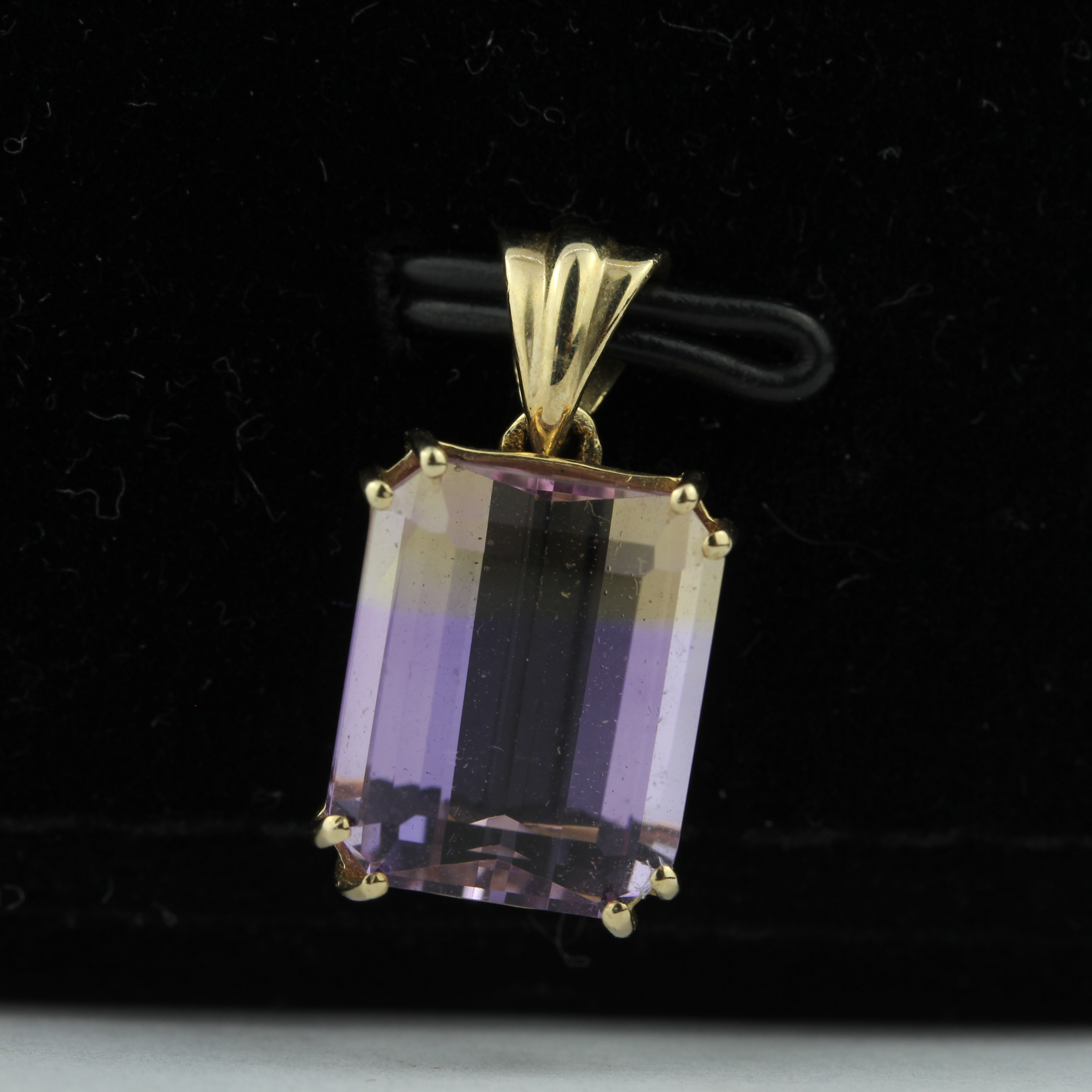 A 9ct yellow gold pendant set with an emerald cut ametrine, L. 6.8cm.