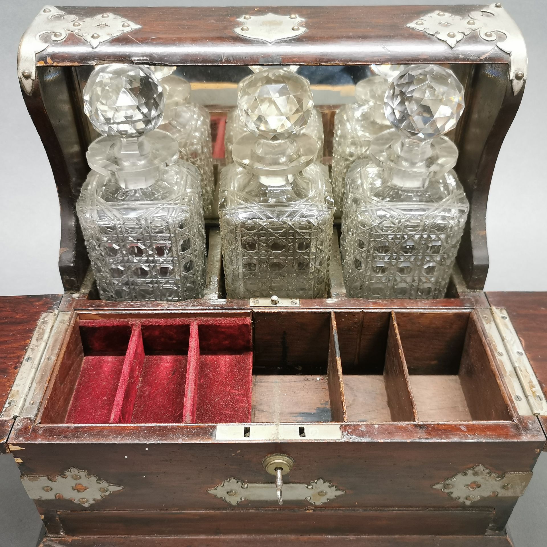 A three bottle cut crystal and mahogany tantalus stand, 36 x 17 x 32cm. - Image 2 of 4