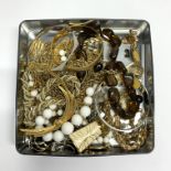 A good box of gold plated costume jewellery.
