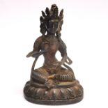 A Sino-Tibetan bronze figure of a seated Tara, H. 21cm. Some remnants of gilding.