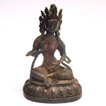 A Sino-Tibetan bronze figure of a seated Tara, H. 21cm. Some remnants of gilding.