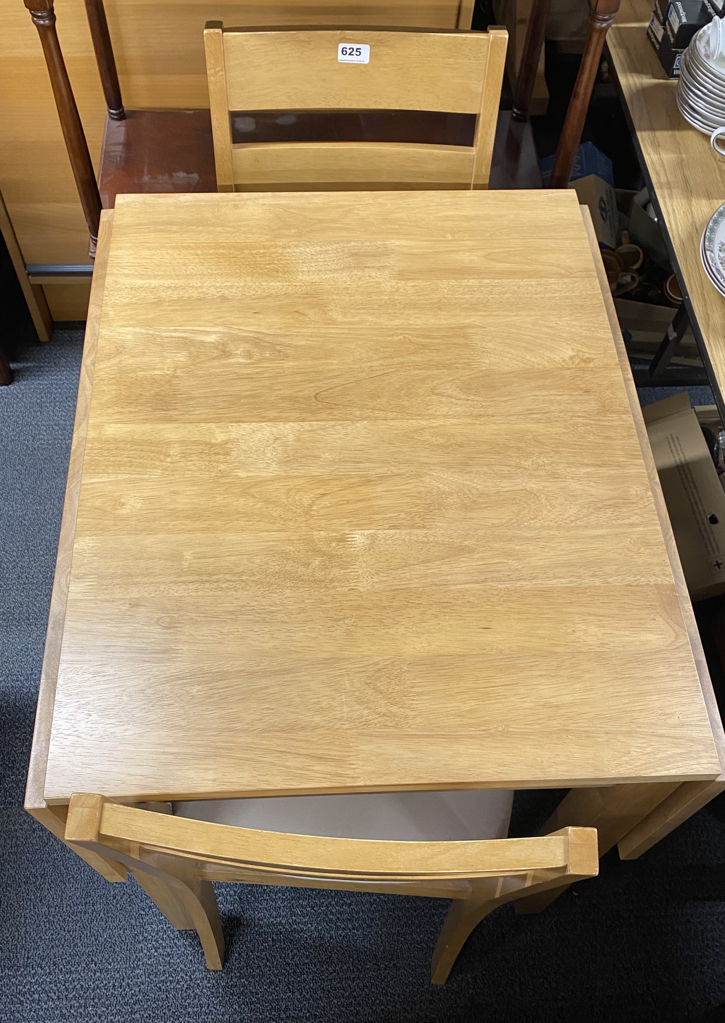 A contemporary drop leaf beechwood kitchen table and two chairs. - Image 2 of 2