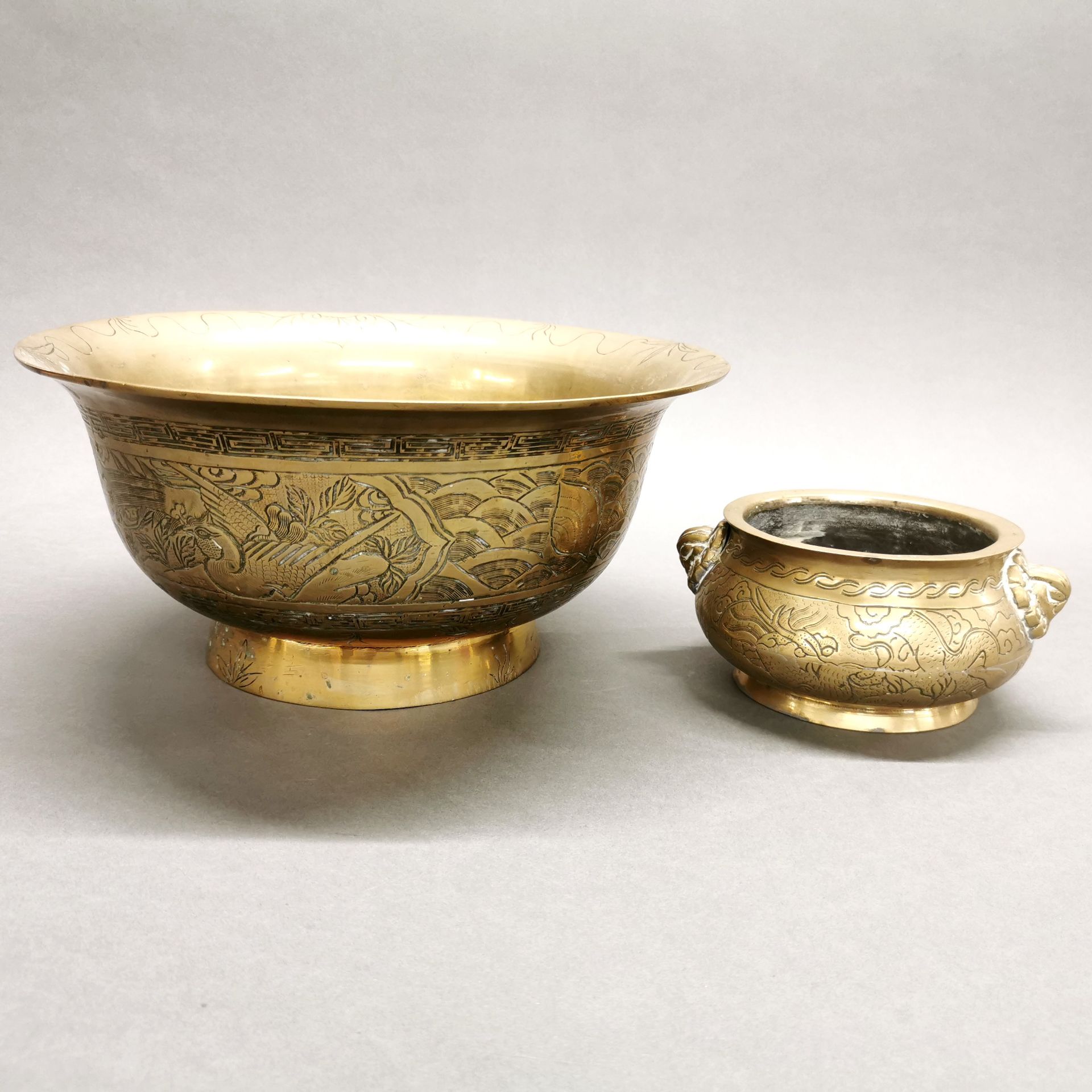 A large early 20thC Chinese engraved brass bowl, dia. 32.5cm. Together with a similar period