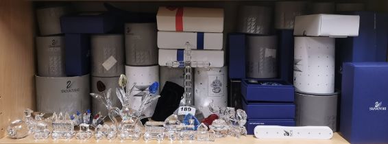 A collection of mixed Swarovski crystal items mostly with boxes including train and cross, cross