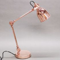 A copperised angle desk lamp.