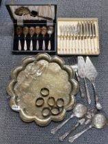 An engraved Indian brass tray, dia 38cm. Together with a group of silverplated items.