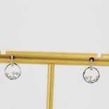 A pair of 9ct white gold diamond set earrings, L. 1.1cm.