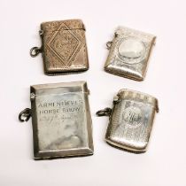 A group of four hallmarked silver vesta cases, includes a case marked for a trench horse show at