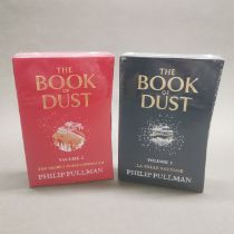 Two sealed hardback volumes of La Belle Sauvage and The Secret Commonwealth by Phillip Pullman.