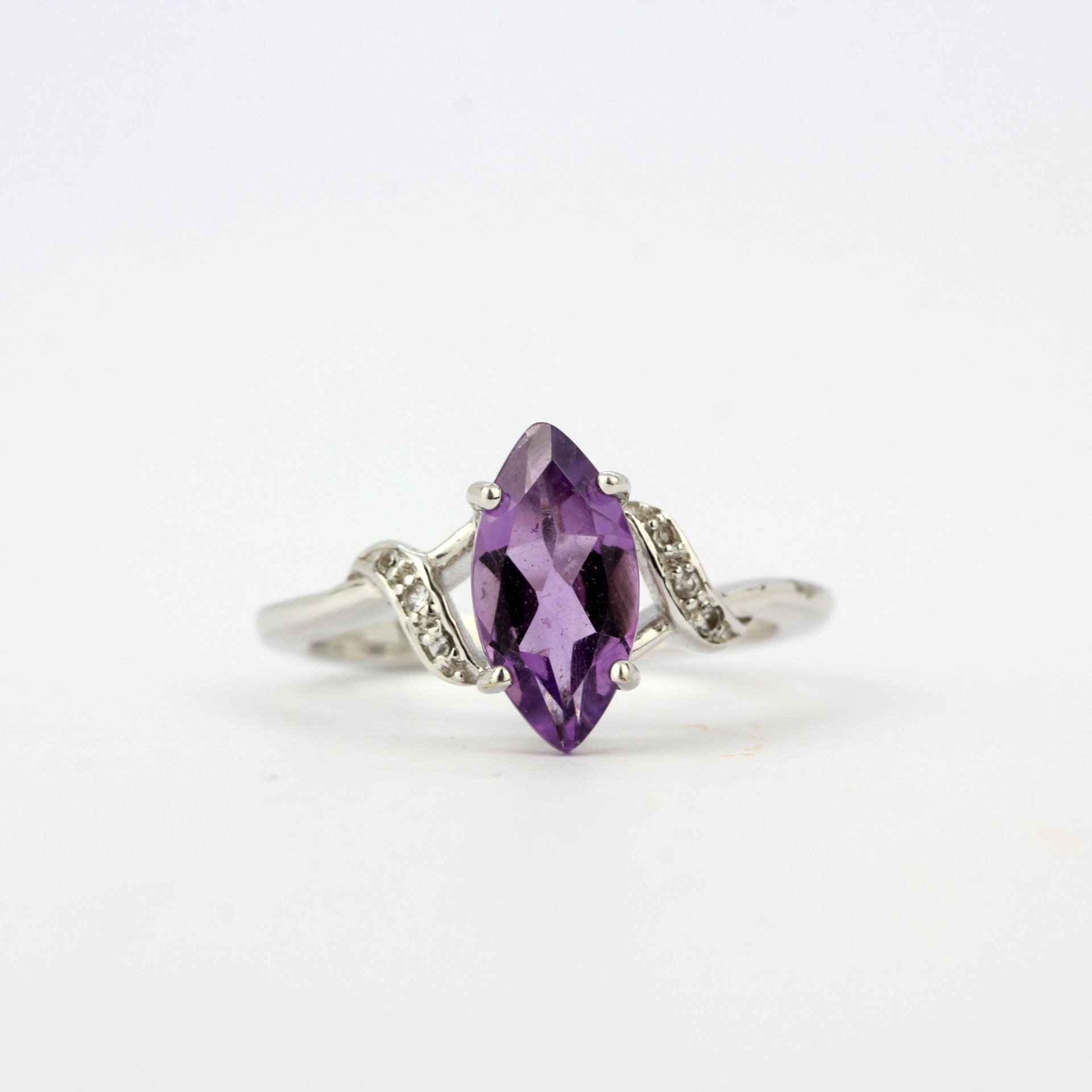 A 9ct white gold ring set with a marquise cut amethyst and diamonds, ring size N.5.