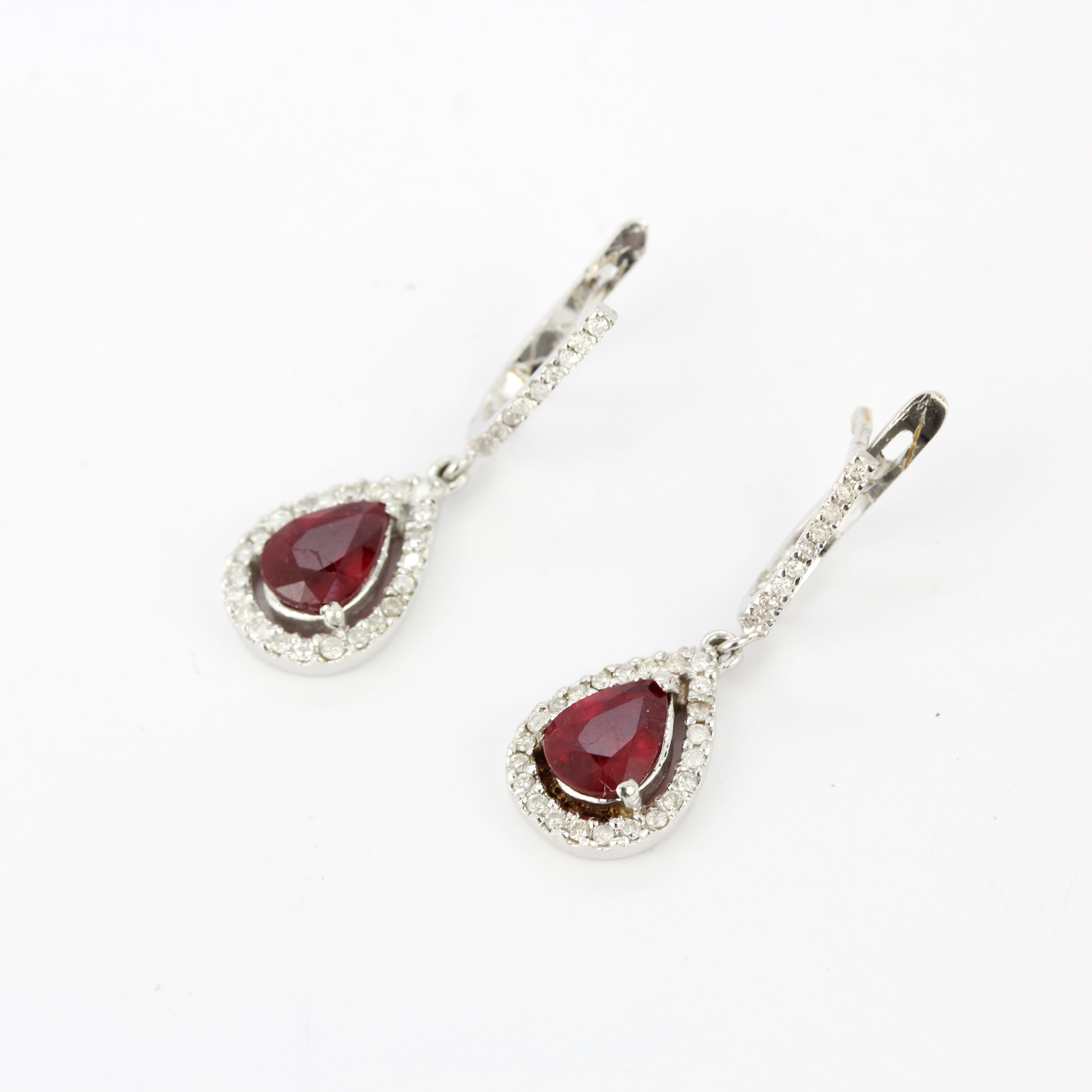 A pair of 18ct white gold drop earrings set with pear cut rubies and diamonds, L. 1.8cm. - Image 4 of 4