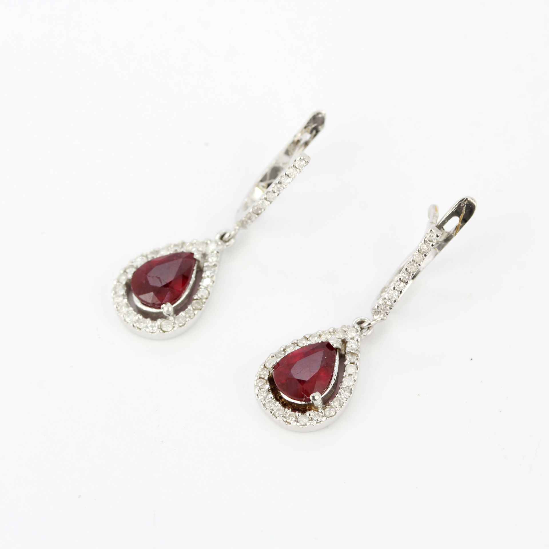 A pair of 18ct white gold drop earrings set with pear cut rubies and diamonds, L. 1.8cm. - Image 4 of 4